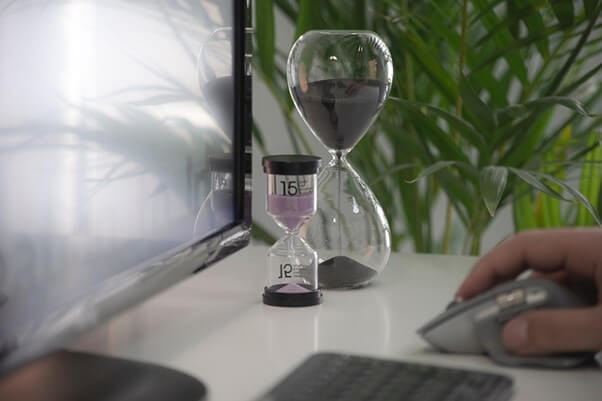 clear hour glass on white table