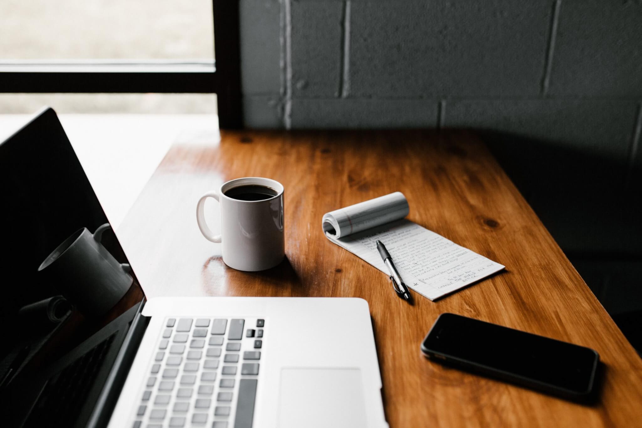 MacBook Pro, white ceramic mug,and black smartphone on table, Technology Move