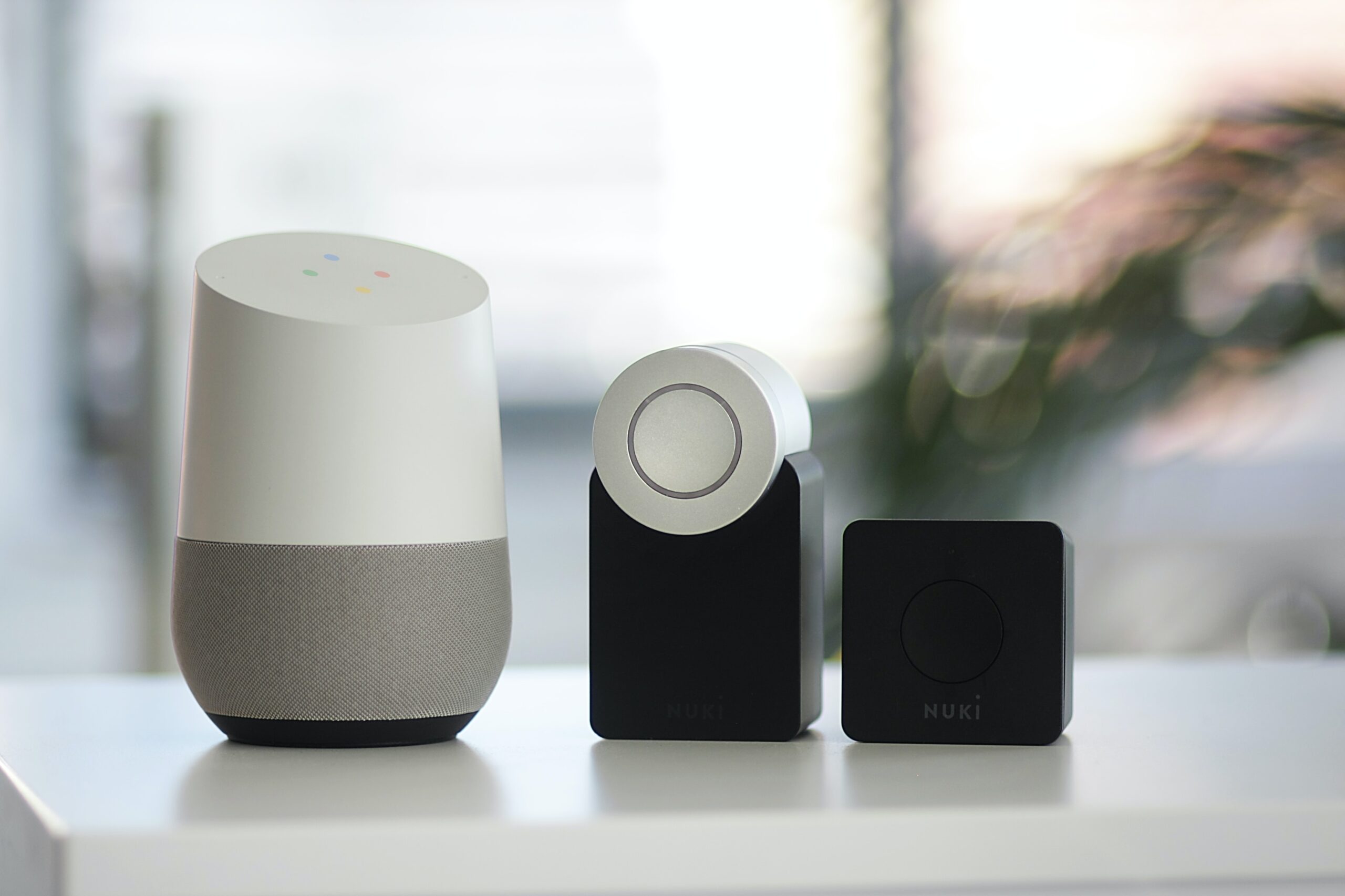 white and gray Google smart speaker and two black speakers - One of the Smart Home Devices