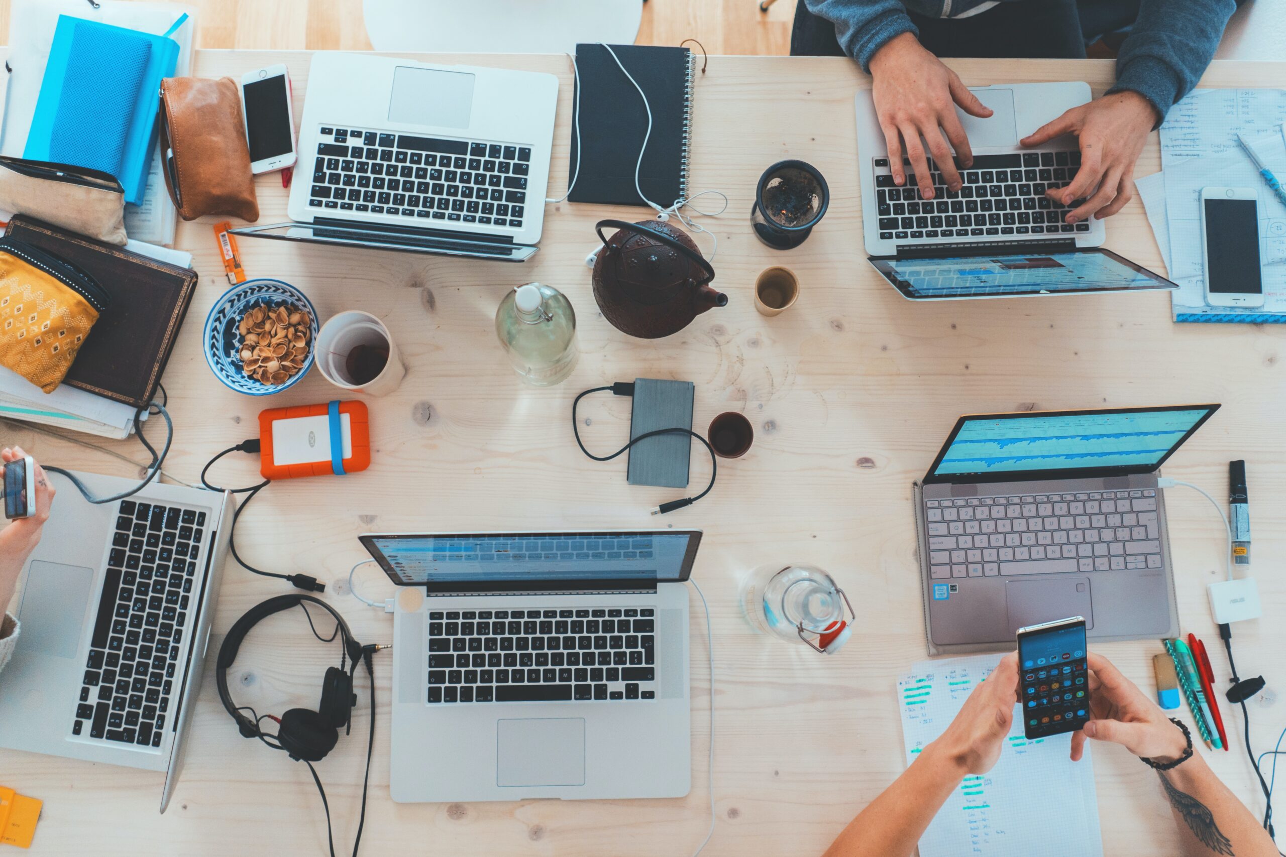 people sitting down near table with assorted laptop computers, Future of Smart Tech Innovations