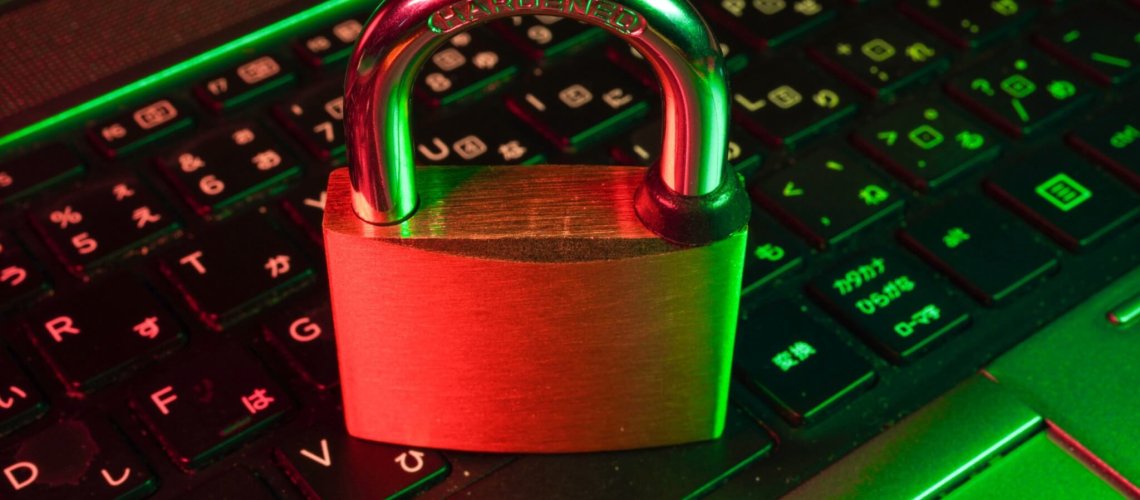red padlock on black computer keyboard, vulnerability management
