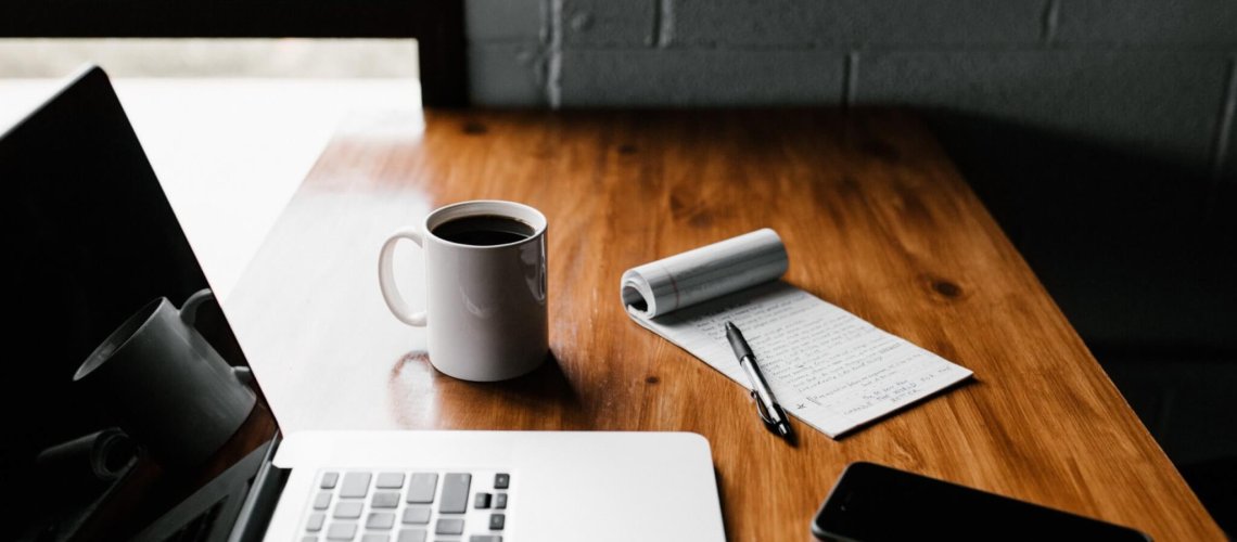 MacBook Pro, white ceramic mug,and black smartphone on table, Technology Move