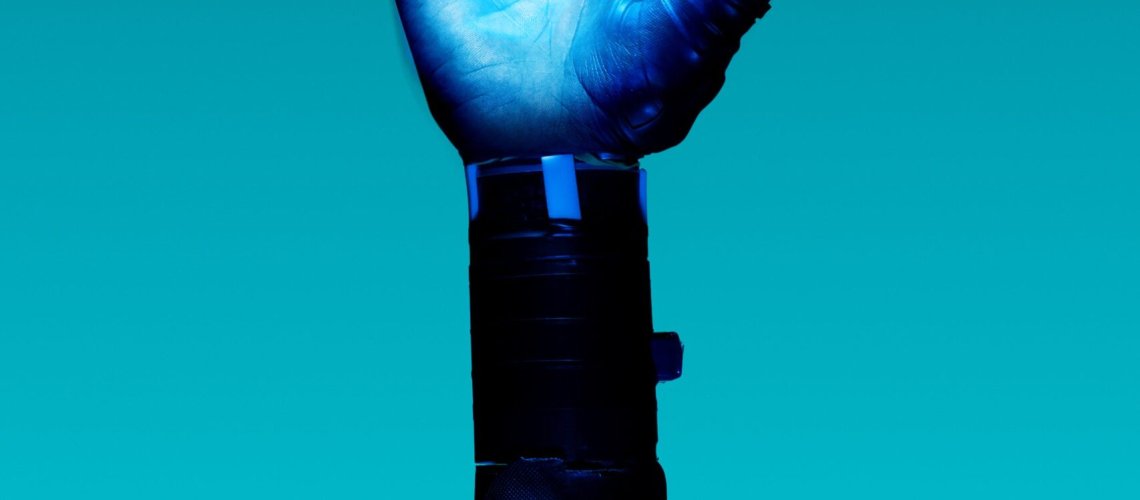 alt="Free Prosthetic Arm on Blue Background Stock Photo"