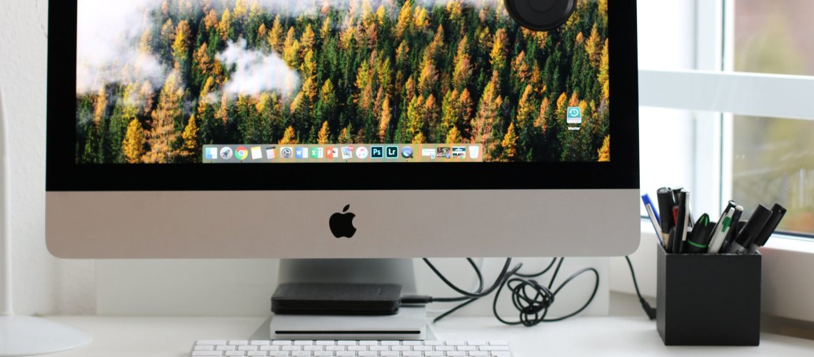 Free Turned on Silver Imac With Might Mouse and Keyboard Stock Photo for Sustainable Tech Habits