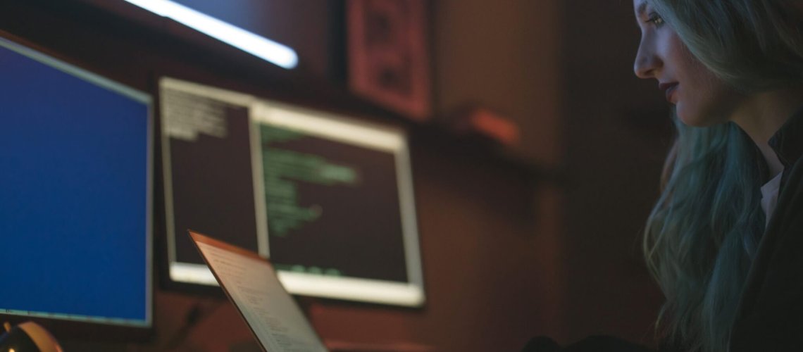 IT security, Free Side View of a Woman Using a Laptop Stock Photo