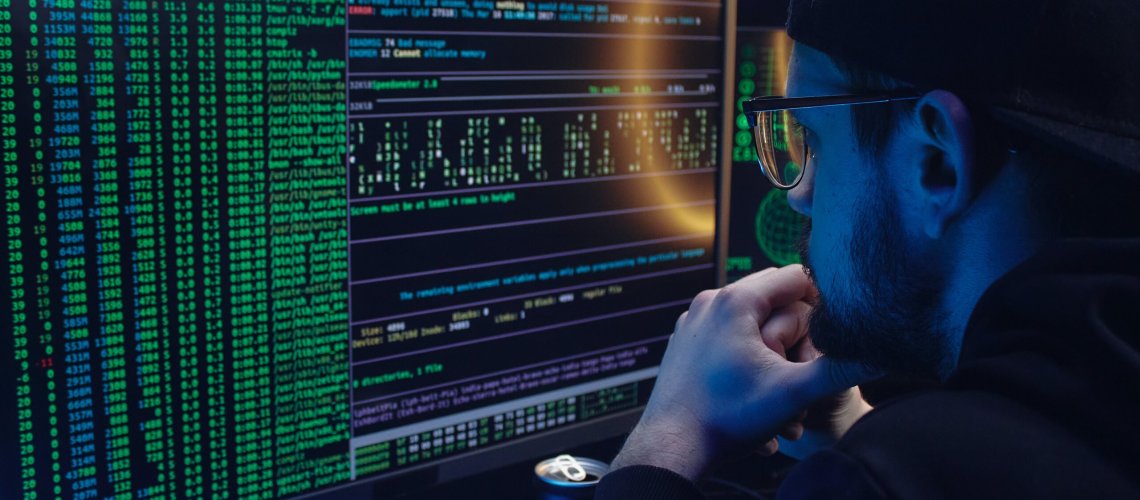 Free A Man Looking at a Computer Screen with Data Stock Photo