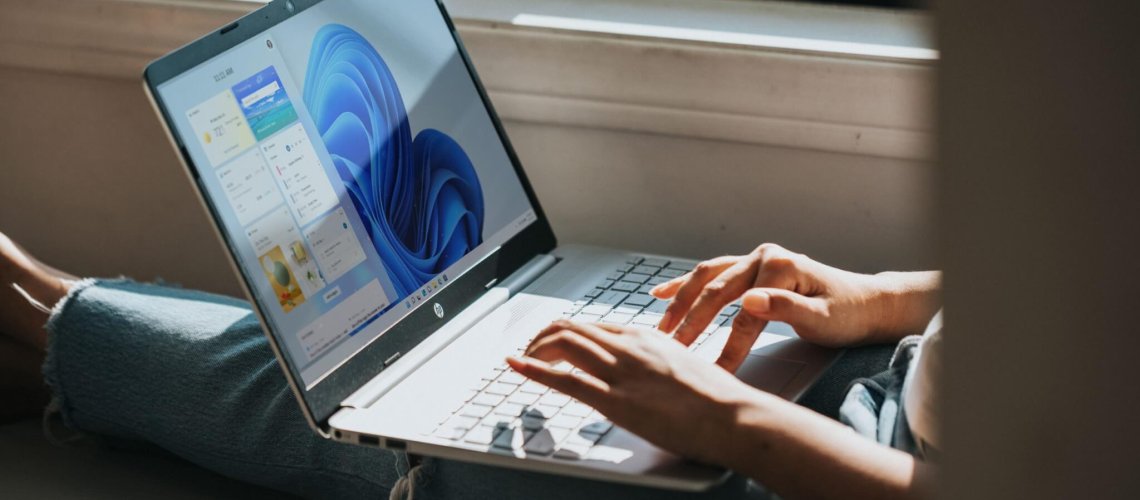 person using Windows 11 computer on lap
